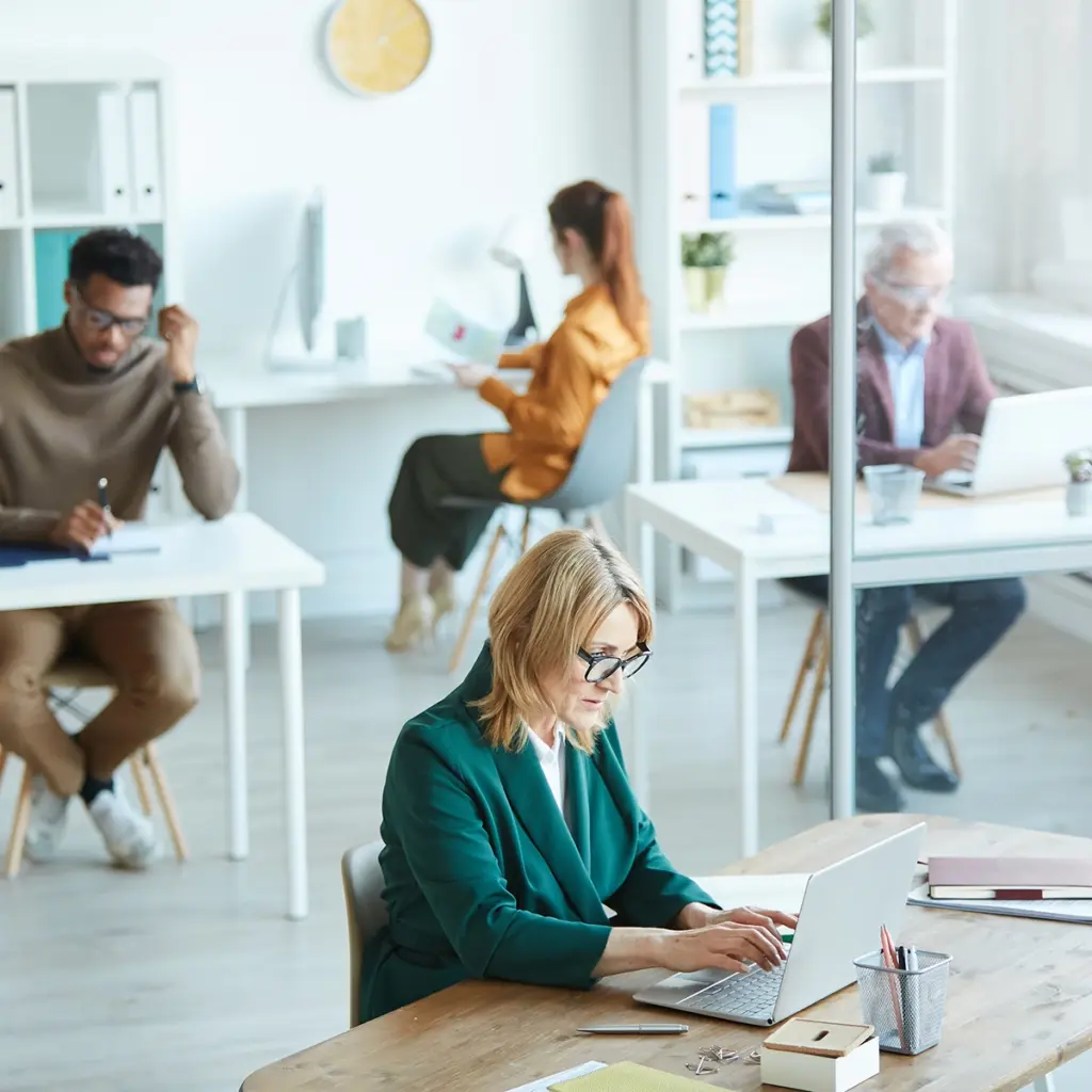 Flera personer arbetar tillsammans i öppen kontorsmiljö